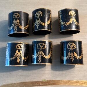 Set of six black metal tole paint napkin rings with gold paint